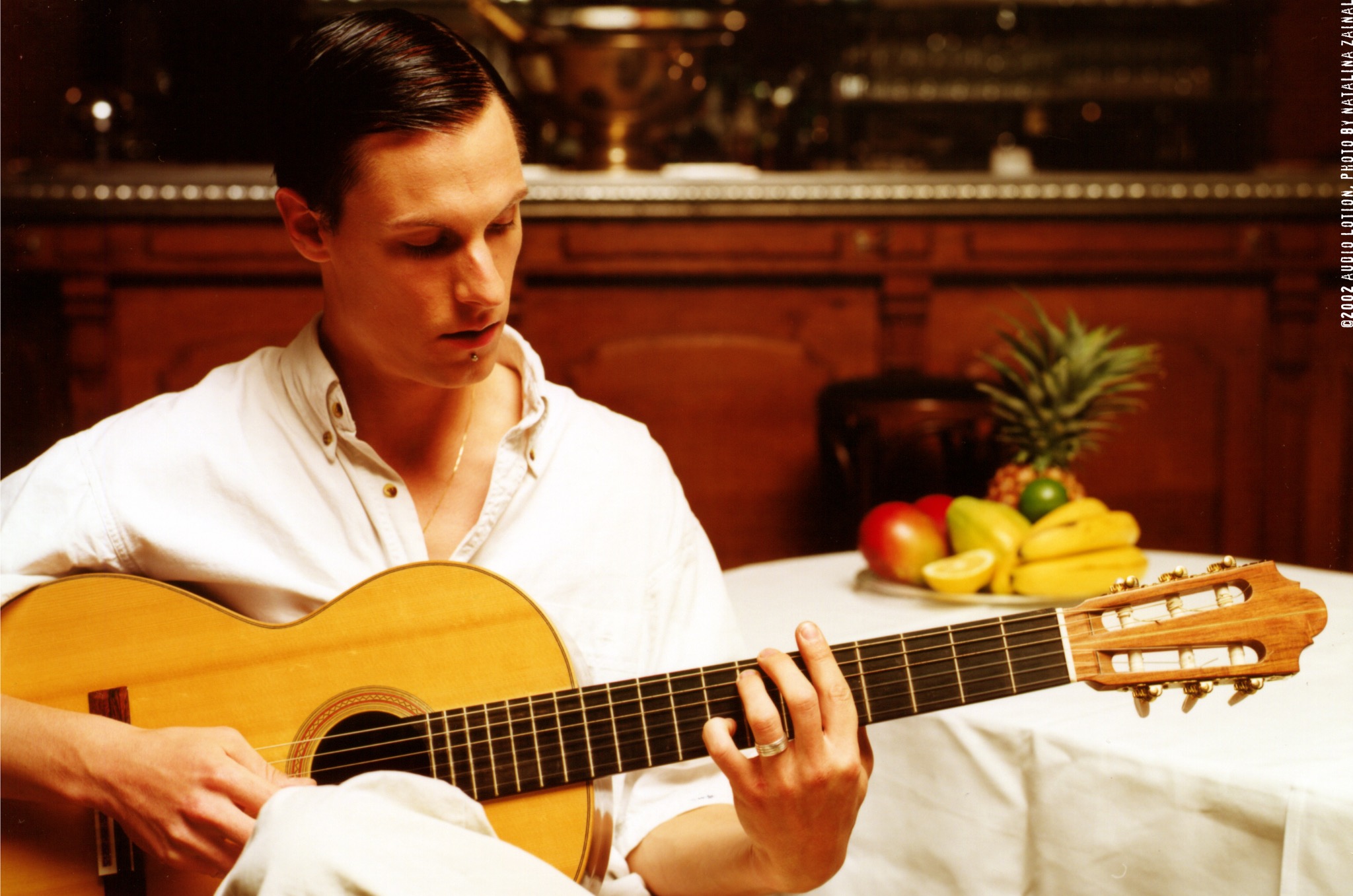 Guitarist in a white shirt with a classical guitar