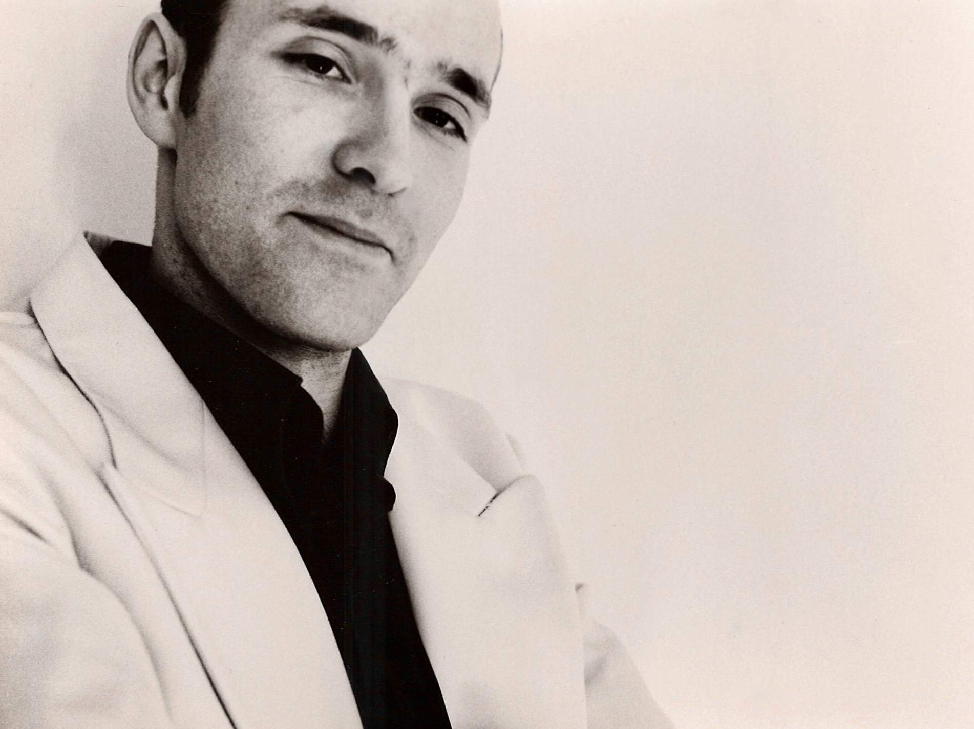Black and white portrait of a member of Audio Lotion in a light jacket