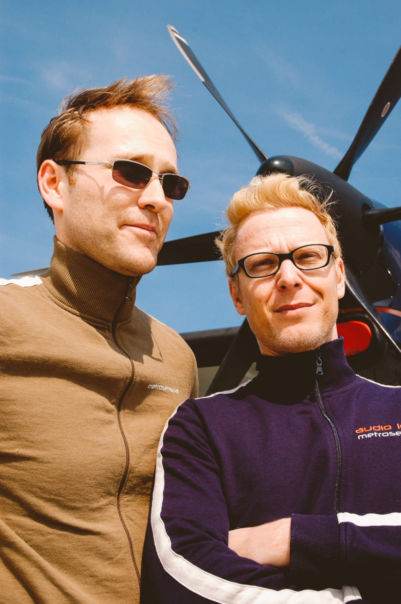 Portrait of the two musicians in front of an aircraft propeller